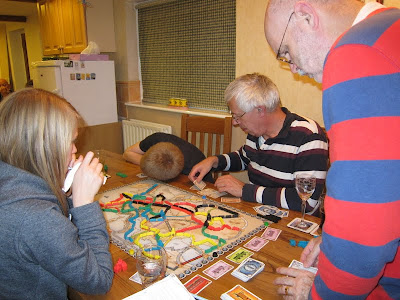Ticket To Ride: Europe - The players with what looks like one listening for the train coming down the track!!