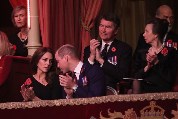 Kate Middleton wore Roland Mouret asymmetric neck dress. Meghan Markle wore Stella McCartney tie detail coat