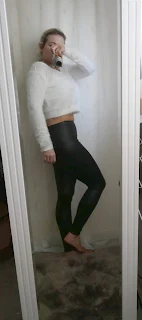 mirror selfie woman in white fluffy top and leather look leggings