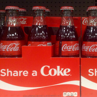 customer photo of soda bottles featuring the #shareacoke marketing campaign