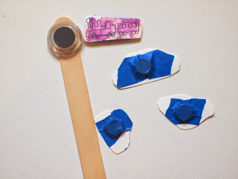 tape your magnets onto your popsicle stick and the back of your pieces