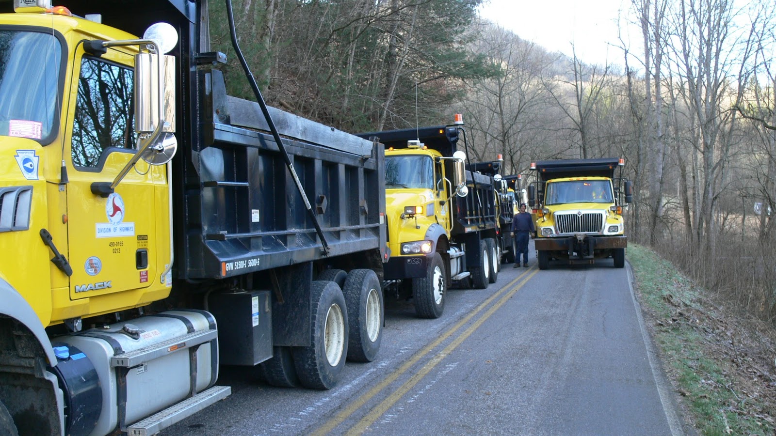 NCDOT Dumptrucks lined up to carry away dirt and debris