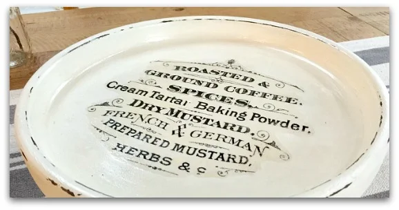 White pedestal plate with writing