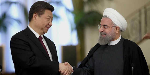 FILE PHOTO: Chinese President Xi Jinping (left) shakes hands with Iranian President Hassan Rouhani, as they pose for a photograph in an official ceremony, at the Saadabad Palace in Tehran, Iran, Jan. 23, 2016. / Source: IRNA