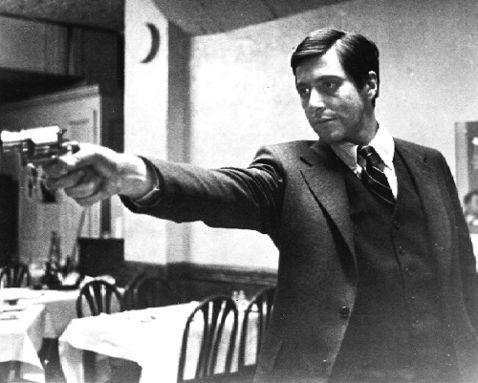 Al Pacino firing a gun in The Godfather  movieloversreviews.filminspector.com