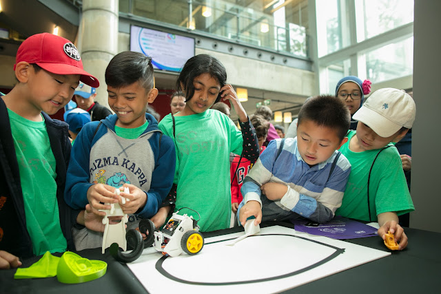 Photo of students interacting with tech in Innovate Alley, from creating mini-ziplines to building their own 3D printed objects and much more.