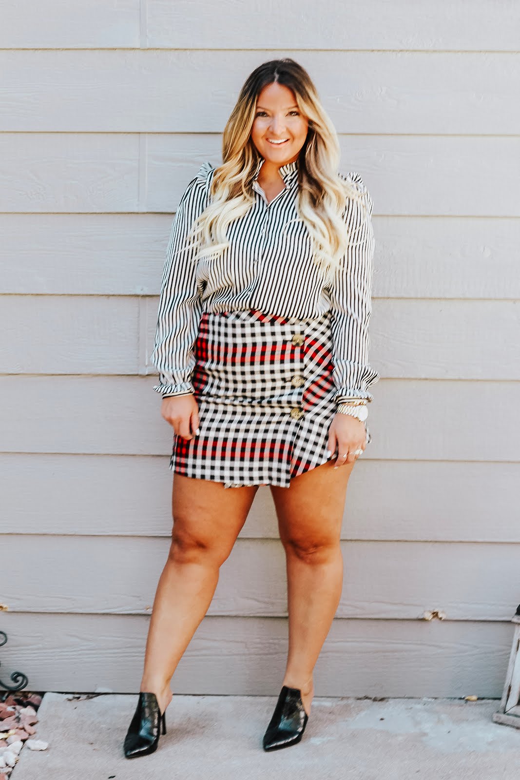 Plaid mini skirt styled for Fall, featured by top Denver fashion blog, Delayna Denaye: blonde woman smiling and wearing a Who What Wear plaid mini skirt, Who What Wear mule pumps, Who What Wear striped ruffle blouse, Amazon bangle and Michael Kors watch