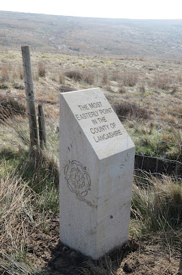 A white stone waymarker, with a Lancashire rose carved into its side and the caption, "The most easterly point in the County of Lancashire"