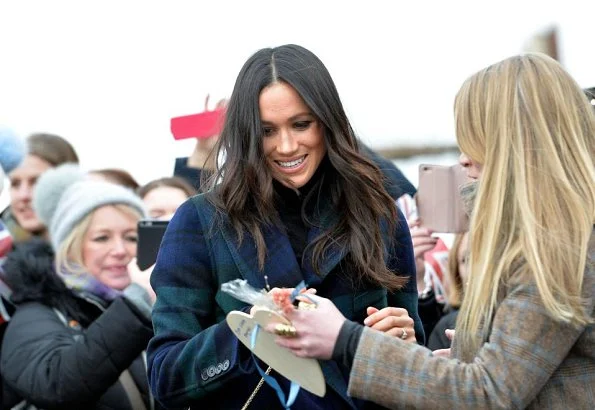 Meghan Markle wore a double-breasted tartan wool-blend coat by Burberry during Edinburgh visit. Meghan carried Strathberry Mini crossbody bag