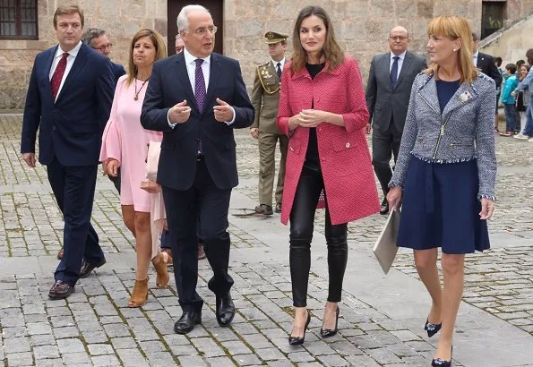 Queen Letizia wore Uterque Black leather pants and Uterque red coat. Queen Letizia wore Carolina Herrera black patent and suede pumps