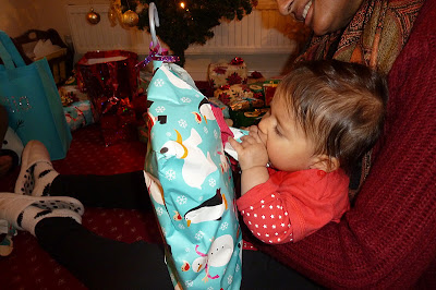 Baby opening Christmas presents