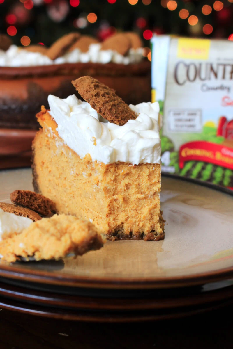 This Pumpkin Cheesecake with Gingersnap Crust is rich, festive, comforting and the perfect dessert for holiday celebrations!  #sponsored #cheesecake #pumpkin #whenwebake