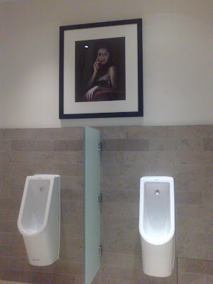 Opera-glasses woman in the gents at St Pancras