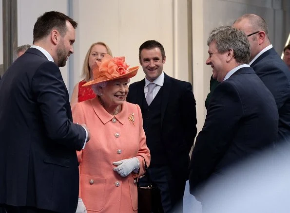 Queen Elizabeth II visited the new Highland Spring factory building in Blackford. The Queen style. wore pink coat and flower dress