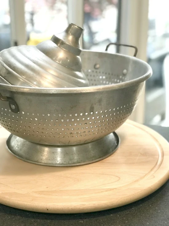 colander and wooden lazy susan