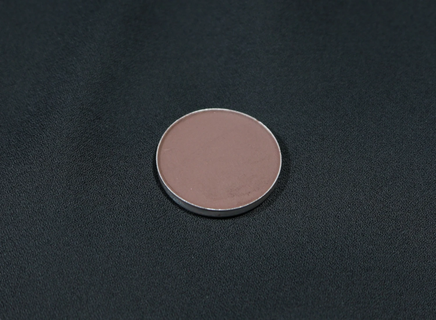 macro close-up of embark single eyeshadow by mac cosmetics on black background