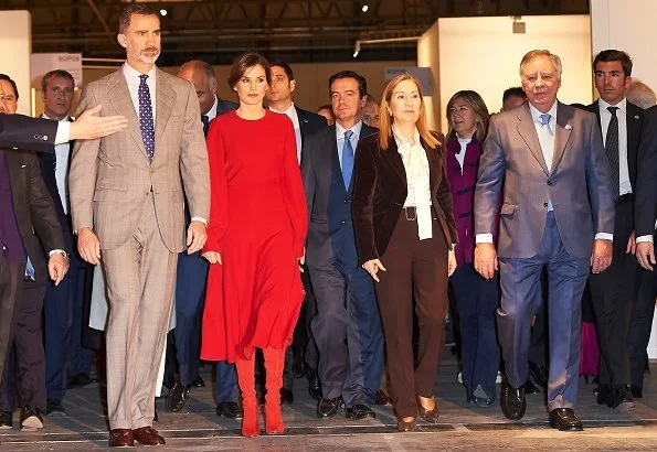Queen Letizia carried Carolina Herrera Animal Print Clutch Bag and she wore Magrit Boots, red skirt and red blouse