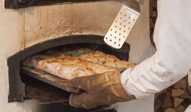 Christmas Market Food: Handbrot being pulled from a wood fired over in Berlin, Germany