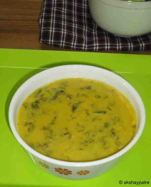 Palak kadhi in a serving bowl