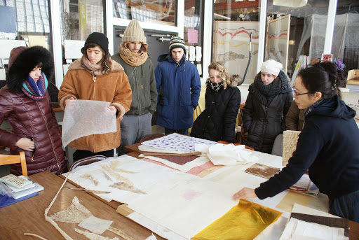 A group of students look at paper 