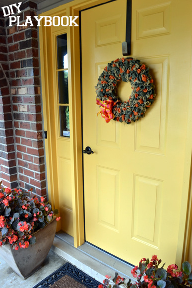 This bright yellow yellow front door really catches people's eyes! It looks great decorated with these wreaths.