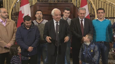 John McCallum welcoming Syrian refugees