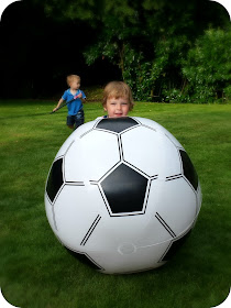 toddler with giant football, 90th family party