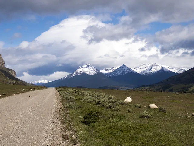 2 Week Patagonia Itinerary: Gravel road with snowcapped mountains in the background in Patagonia Chile