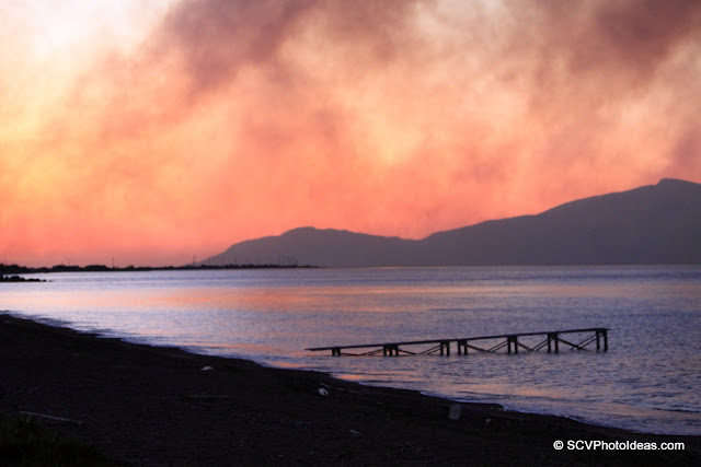 Dawn colors covered by wildfire smoke on the beach