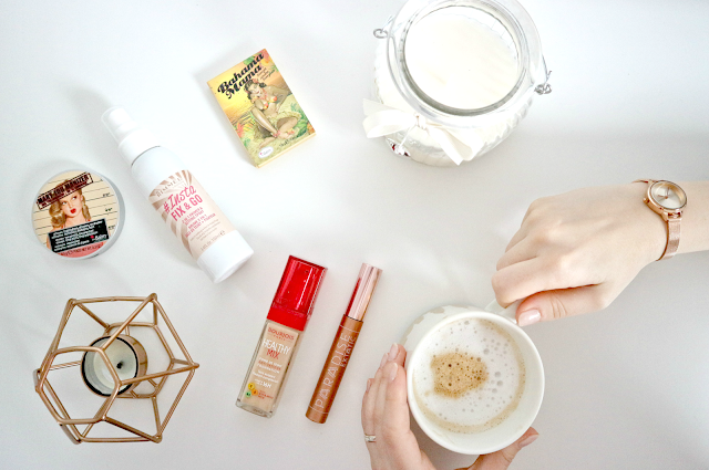 beauty products and coffee mug flatlay