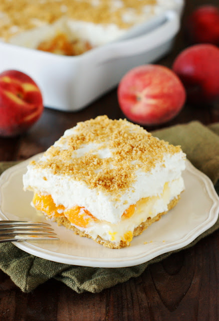 No-Bake Peach Yum Yum Image ~ A classic layered no-bake dessert with a graham cracker crust and peach pie filling sandwiched between two creamy layers.  It's sure to be a hit!   www.thekitchenismyplayground.com
