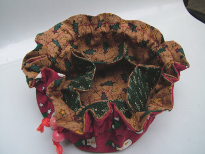 handmade circular jewelry pouch with multiple pockets