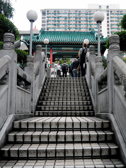 Stairs to the bridge crossing the pond in the garden of Sik Sik Yuen Wong Tai Sin Temple, Hong Kong
