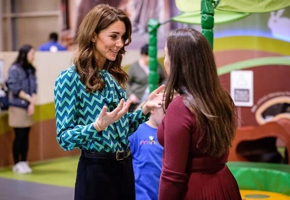 During the visit, Kate Middleton wore a new turquoise and navy print blouse by Tabitha Webb. Tabitha Webb Pansy pussybow in green chevron