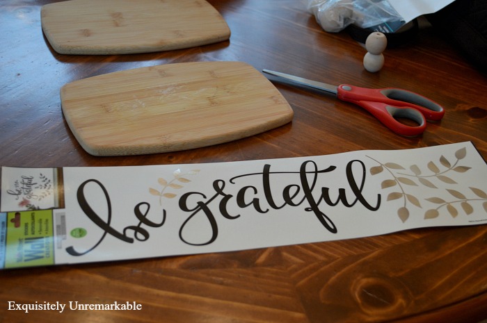 Be Grateful wall decal on table with cutting boards and scissors