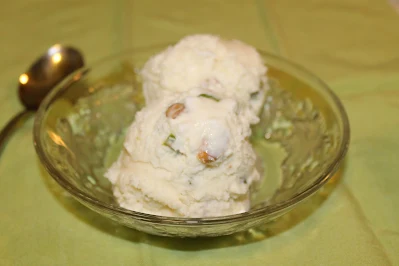 Serving bowl with two scoops of pistachio cardamom ice cream.