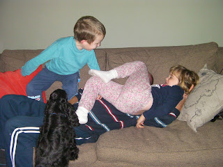 2 children and a dog beating up an adult