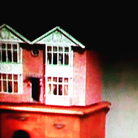 Screen shot of a vintage dolls house in the 1970s TV programme Sapphire and Steel.