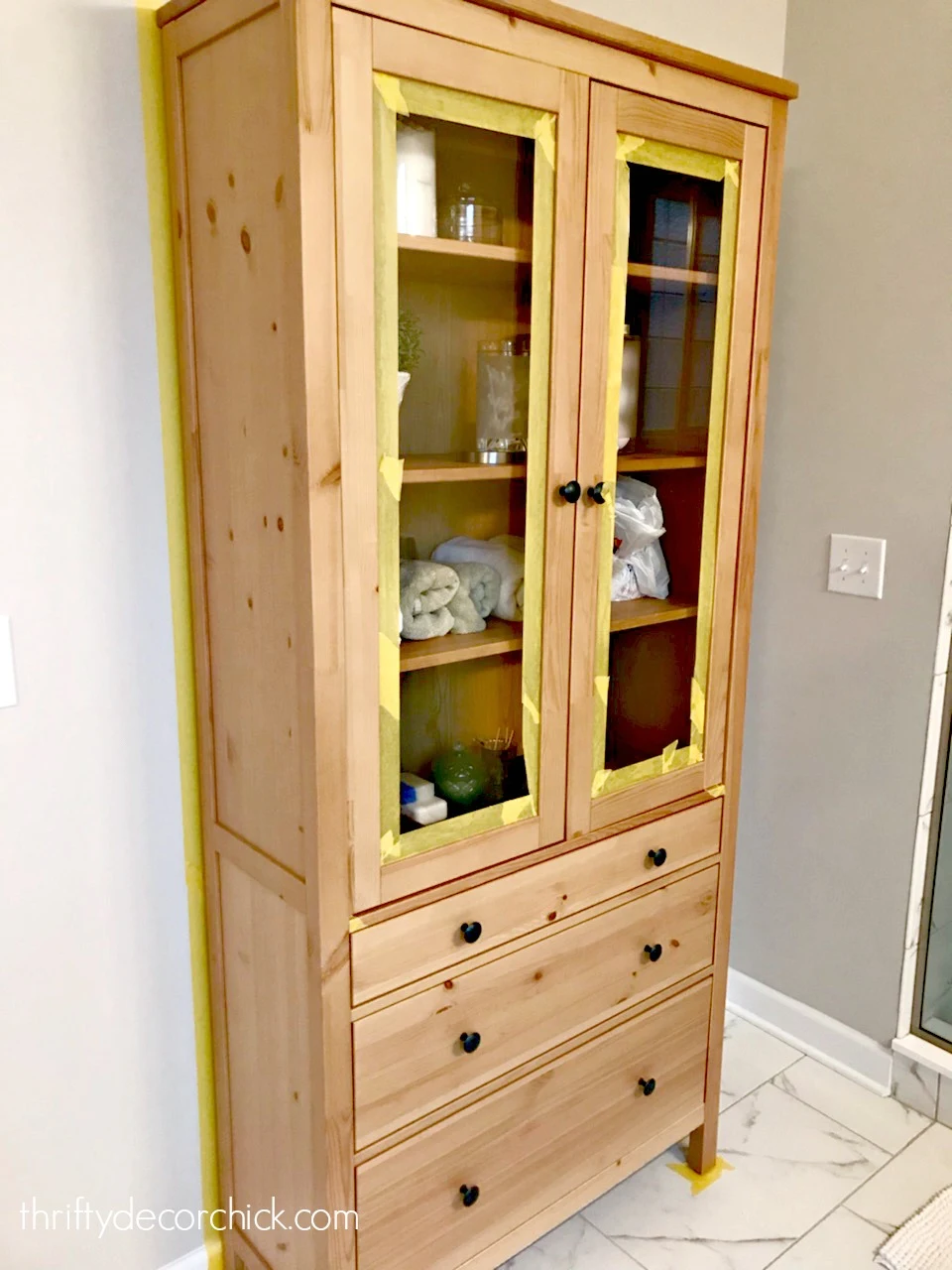 Wood IKEA cabinet with drawers and glass doors