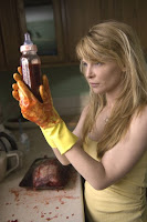 mom fills a baby bottle with blood in the movie Grace (2009)