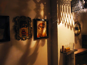 Interior of a modern dolls' house miniature cafe at night.