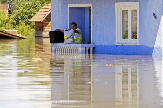 These 16 photos will disturb you... The Balkans in the grip of flood! - A man waits to be rescued from his house during heavy floods in Vojskova, May 19, 2014.