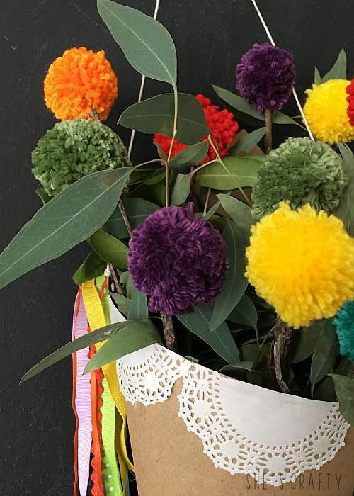 Make rainbow pom pom in a paper cone holder to freshen space for Spring