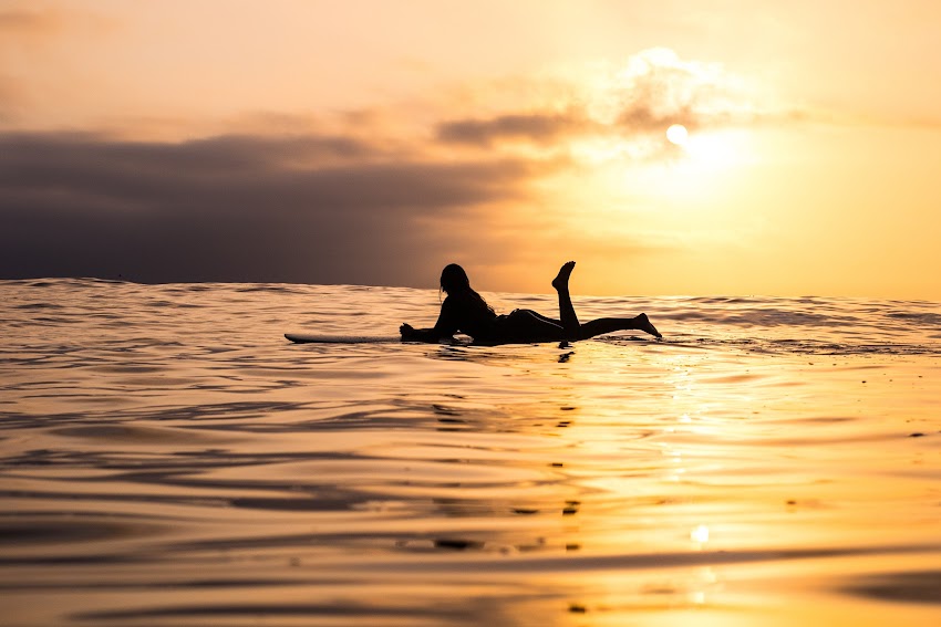 Girl On Surfing Board On The Sea In Sunset Girl On Surfing Board On The Sea In Sunset