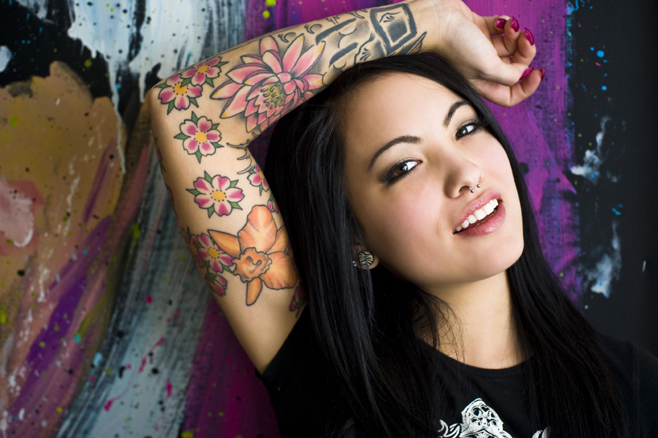 chica con tatuaje de flor de loto en el brazo