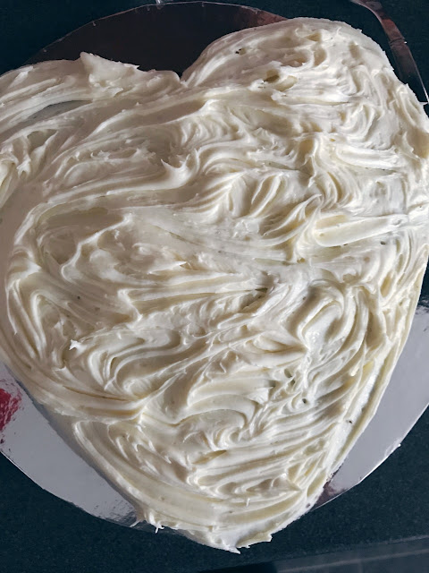 Buttercream icing spooned on to the cake