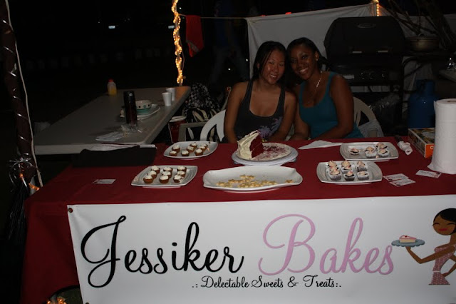 Two women at a cake stall.