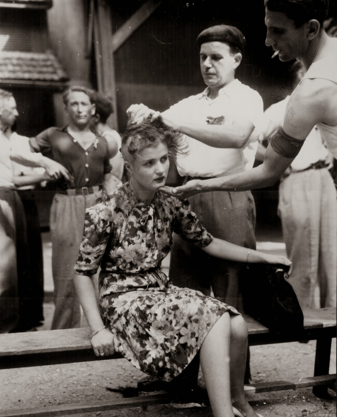 Woman being shaved by civilians to publicly mark her as a collaborator, 1944