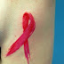 Cancer ribbon tattoo on side body