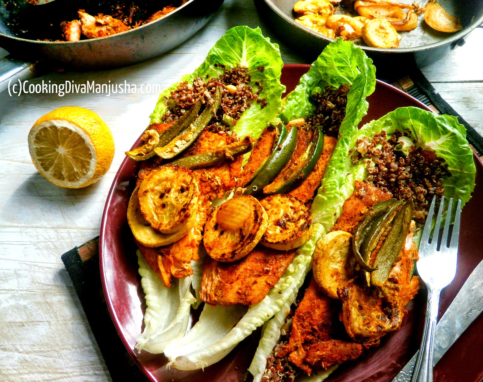 Quinoa salad on a bed of lettuce,pan fried salmon,jalapenos & squash